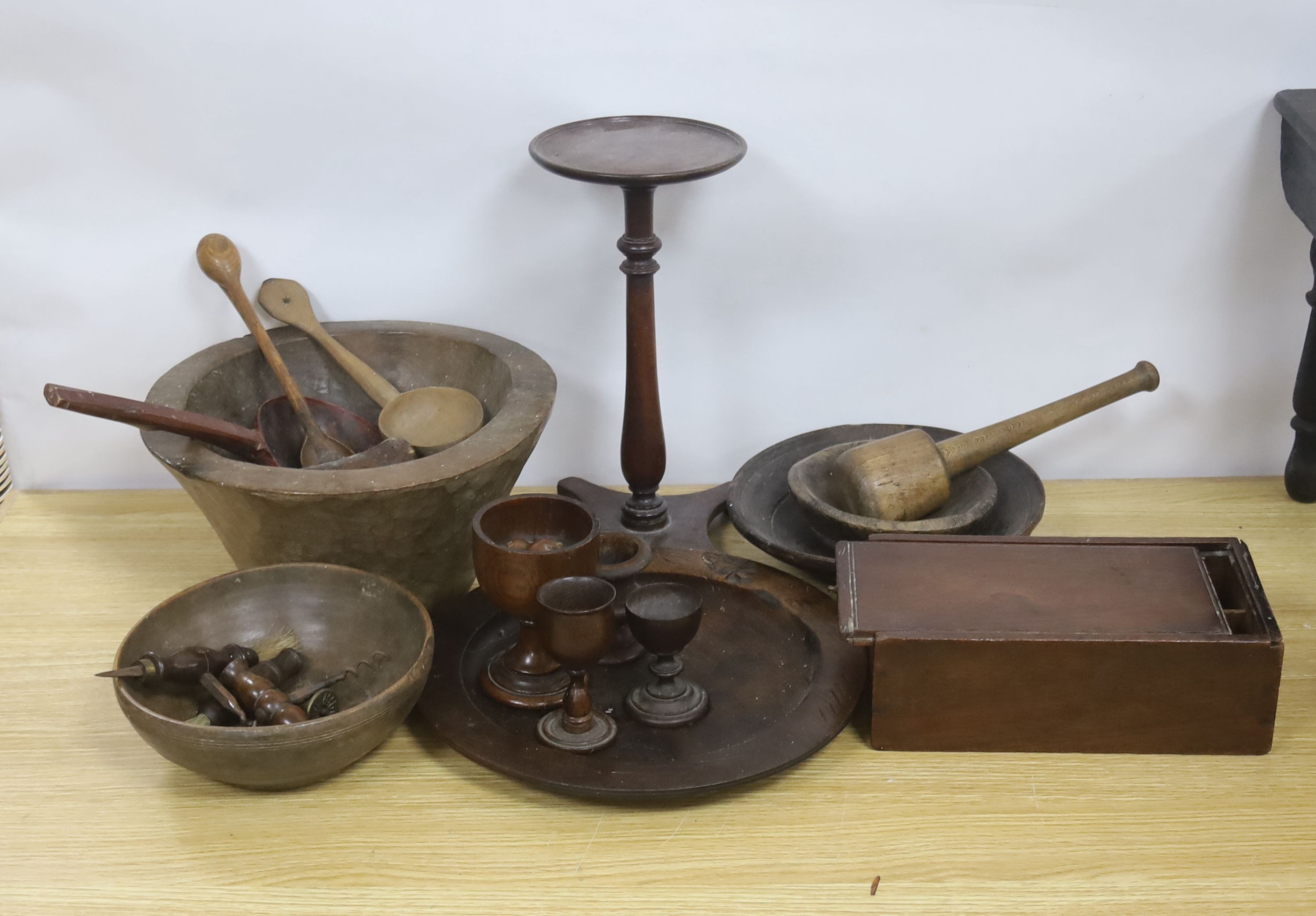 A group of assorted treen including an 18th century sliding lid mahogany box, a candle stand and various goblets etc.